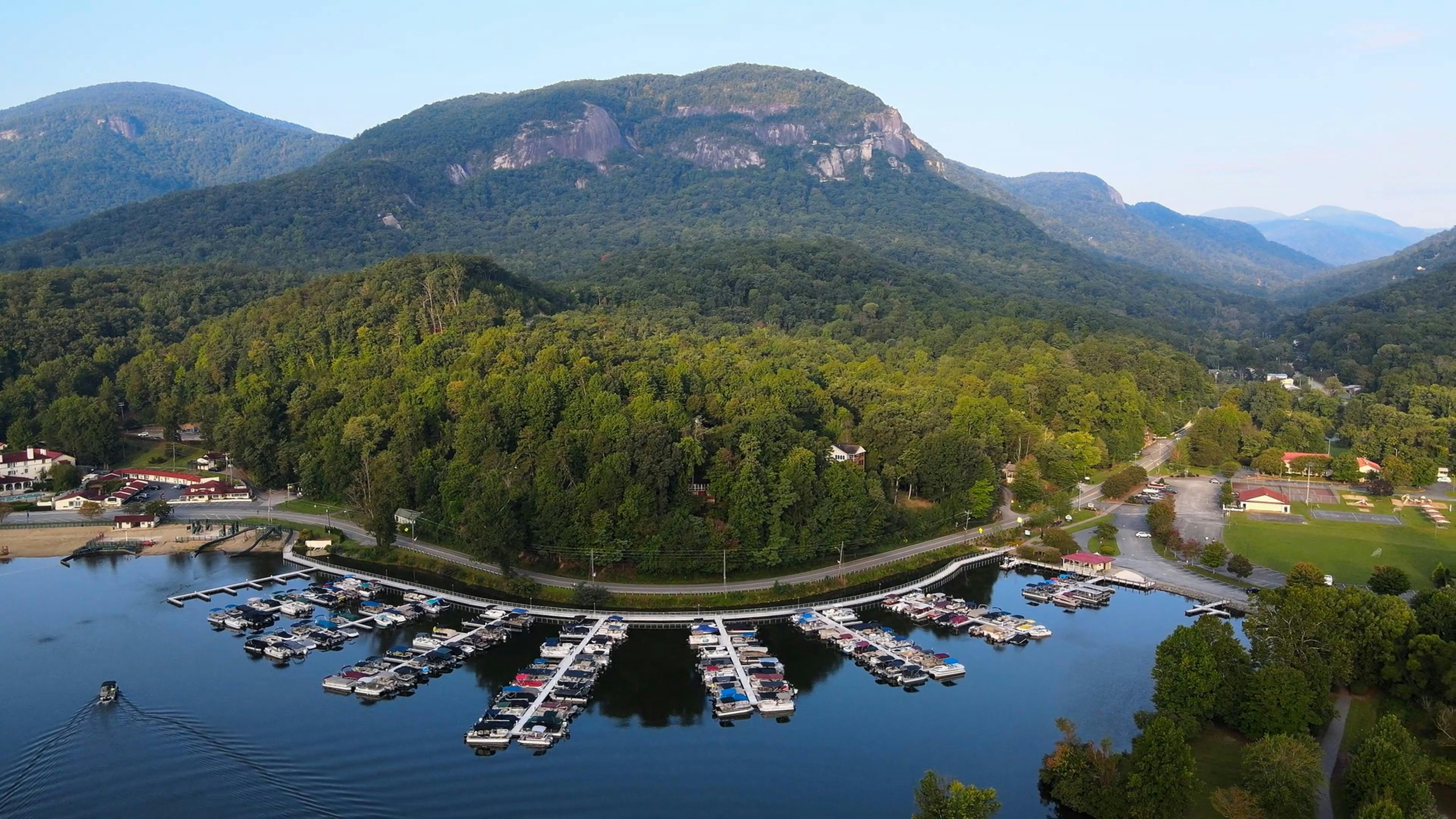 Aerial View of Boats Moored in a Lakeshore Marina With Forested