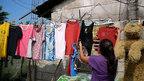women drying clothes under the sun