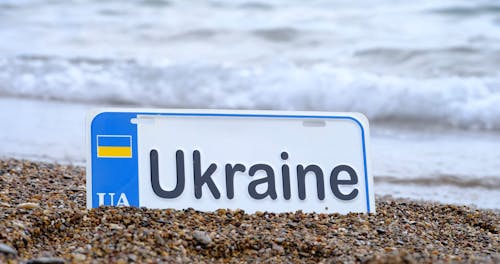 Ukrainian Car Plate on the Beach Shore