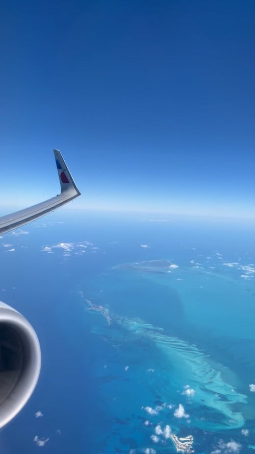 Plane Window View while Flying over the Ocean 