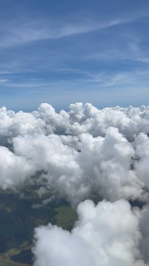 Puffy White Clouds seen from an Airplane Window 