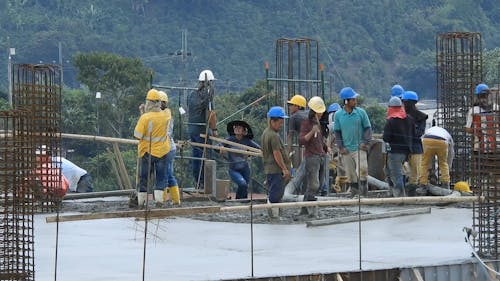 Workers with Shovels at Construction Site