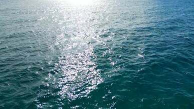 sun reflections on sea in birds eye view