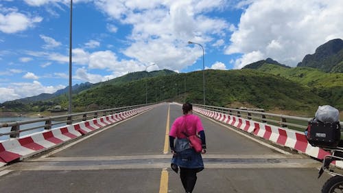 Woman Walking on Bridge