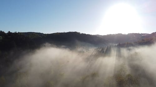 Drone Footage of a Misty Mountain Landscape at Sunset