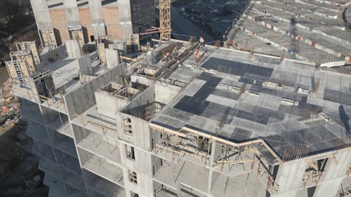 Drone Video of Construction Workers on Top of a Building 