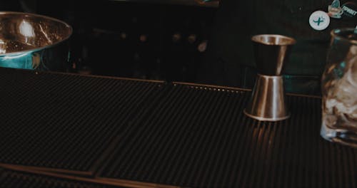 A Barman Placing a Whiskey Bottle on the Counter