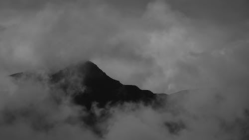 Grayscale Video of Mountain Covered with Clouds