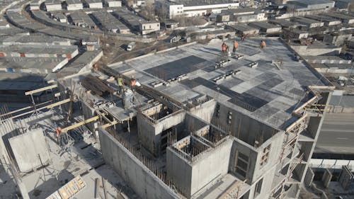 Aerial View of Workers on the Buildings