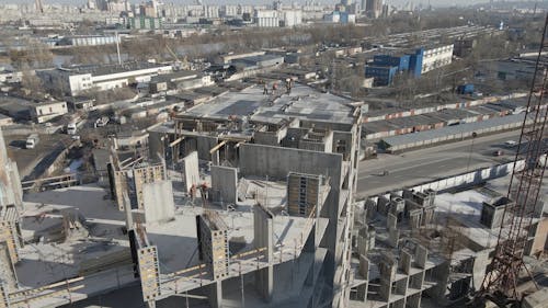 Drone Footage of Workers on a Building by the Highway