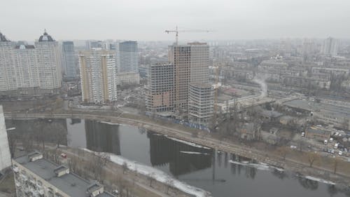 Drone Footage of a Crane by the Building Construction