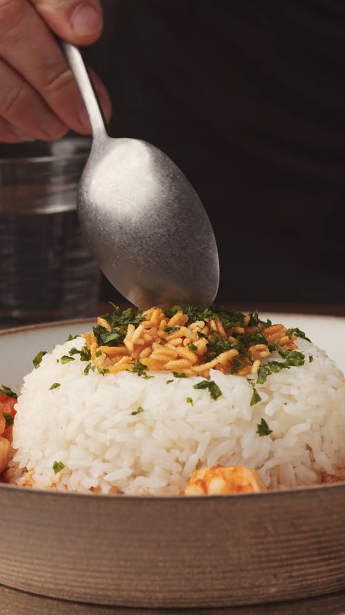 Hand Taking Rice with Spoon