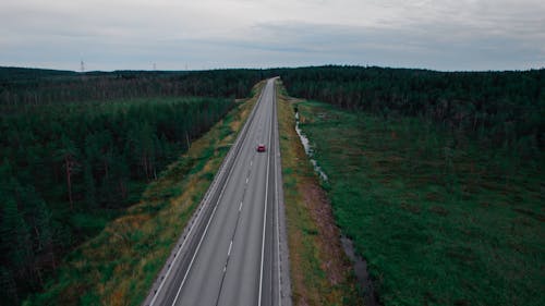 Drone Shot of a Red Car on Road 