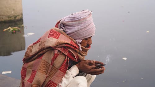 A Man Praying by the Yamuna River in New Delhi, India
