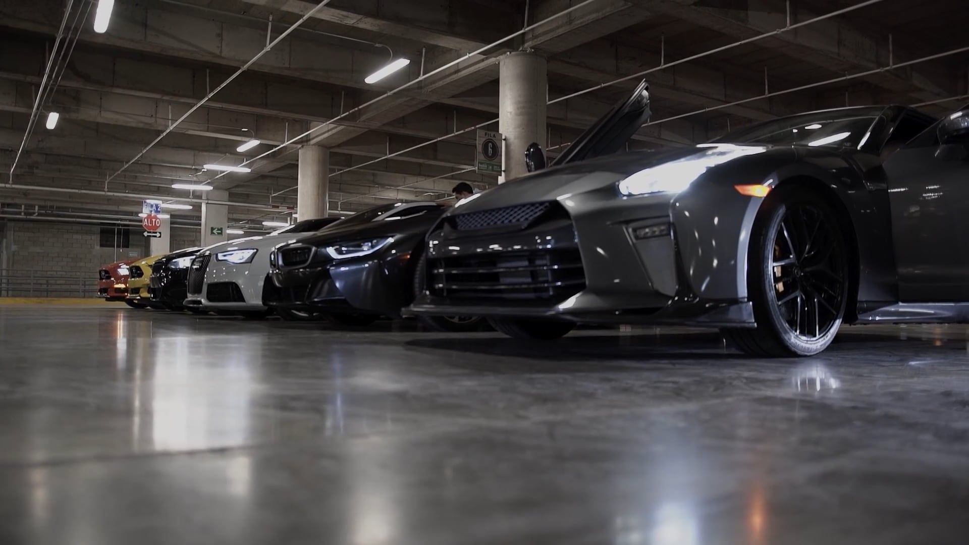 Luxury sports cars lined up in a modern showroom