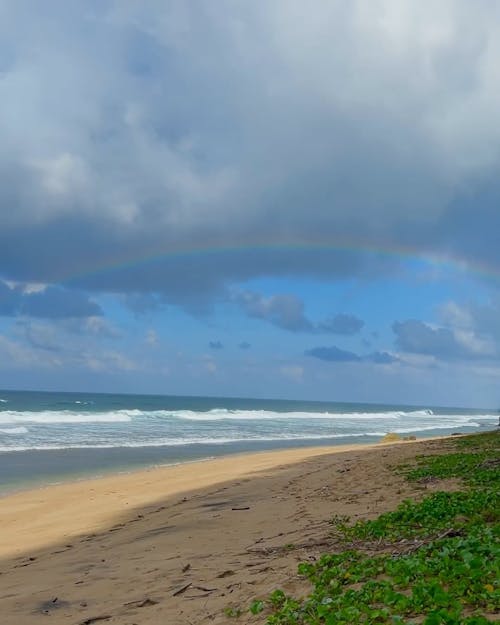 Clouds and Rainbow over Beach
