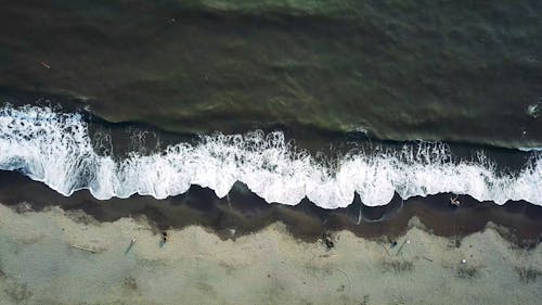 Aerial View of Waves Crushing to the Shore