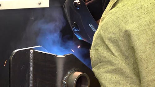 A Worker using a Welding Machine while Working