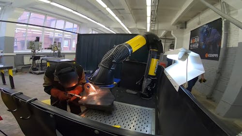 A Man Welding a Metal Sheet 