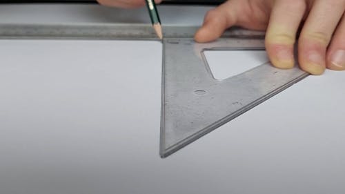 Close up View of a Person Using a Triangle Ruler