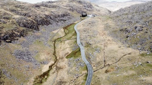 Drone Footage of Moving Cars on Long Road at Snowdon
