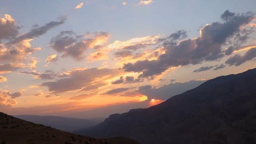 Time Lapse a Dramatic Sunset Sky in a Mountain Landscape 