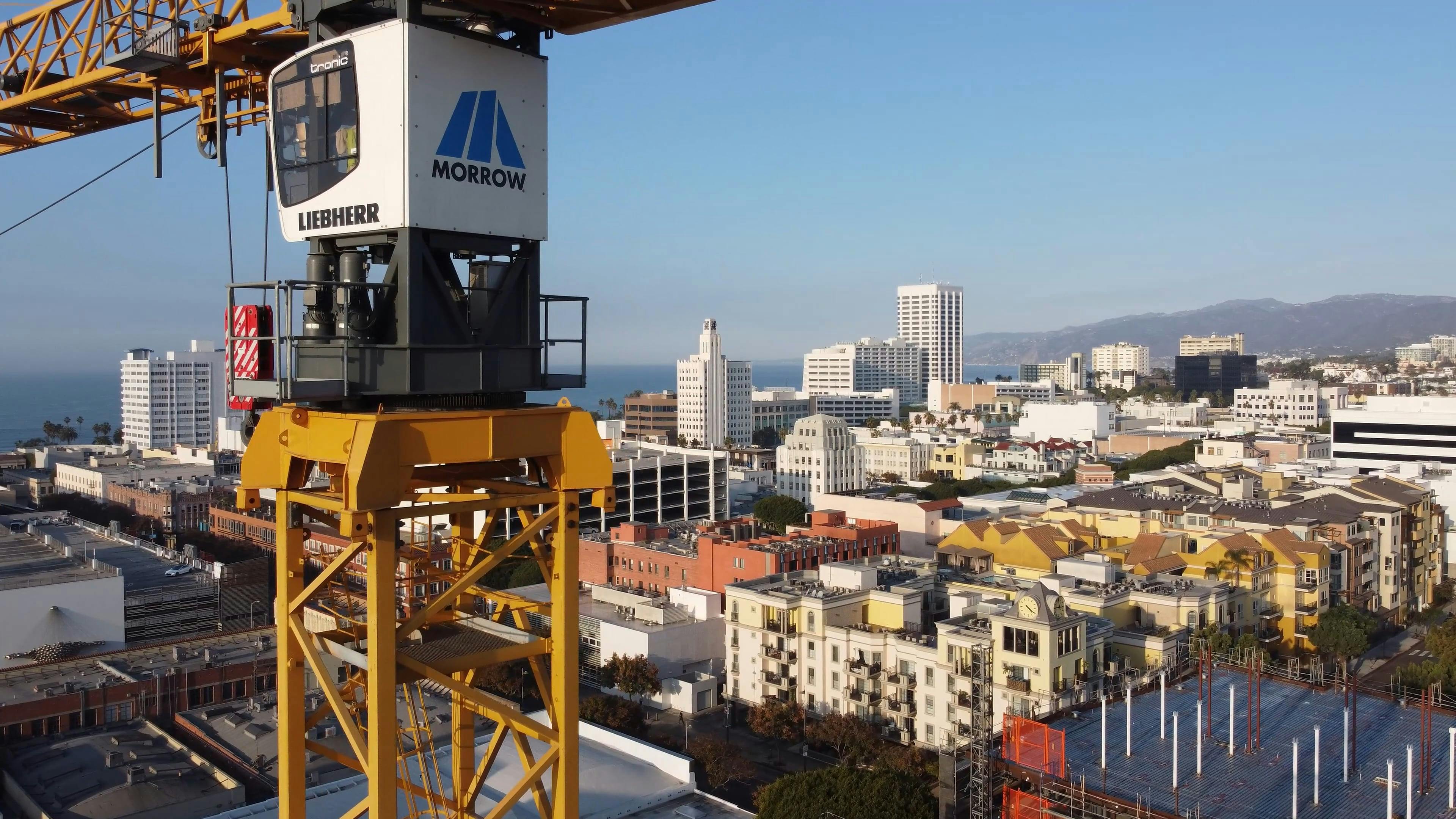 Drone Video of a Construction Crane in a City by the Sea Free Stock