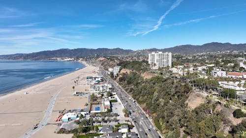 Aerial View of Traffic on a Coastal City Highway