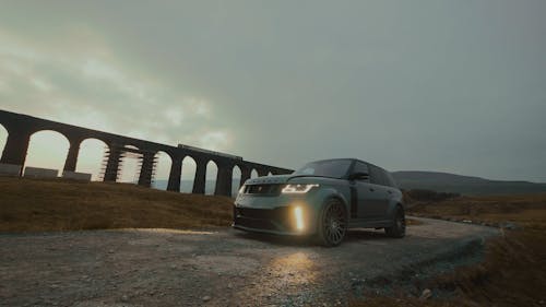 An SUV Parked on a Dirt Road by the Ribblehead Viaduct in Yorkshire, England 