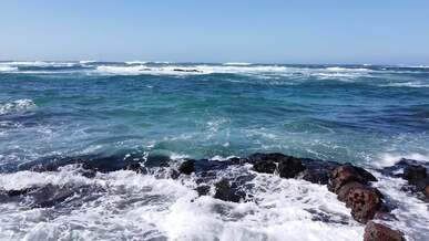 drone video of breaking waves on a rocky shore