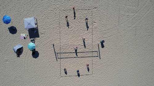 People Playing Volleyball on Beach in Overhead View