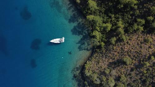 Top View of a Yacht Anchored near the Coast 