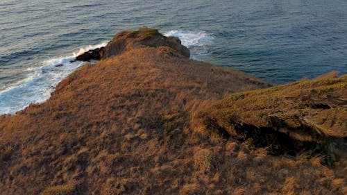 Drone Footage of a Person Standing on a Small Island 