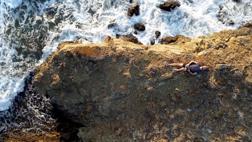 Top View of a Man Lying on a Small Island 