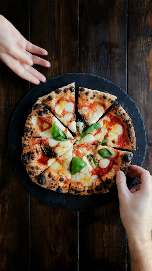 Grabbing Sourdough Neapolitan Style Pizza Slices