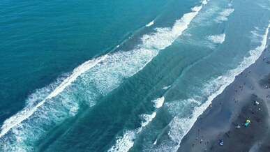 aerial view of breaking waves on the beach