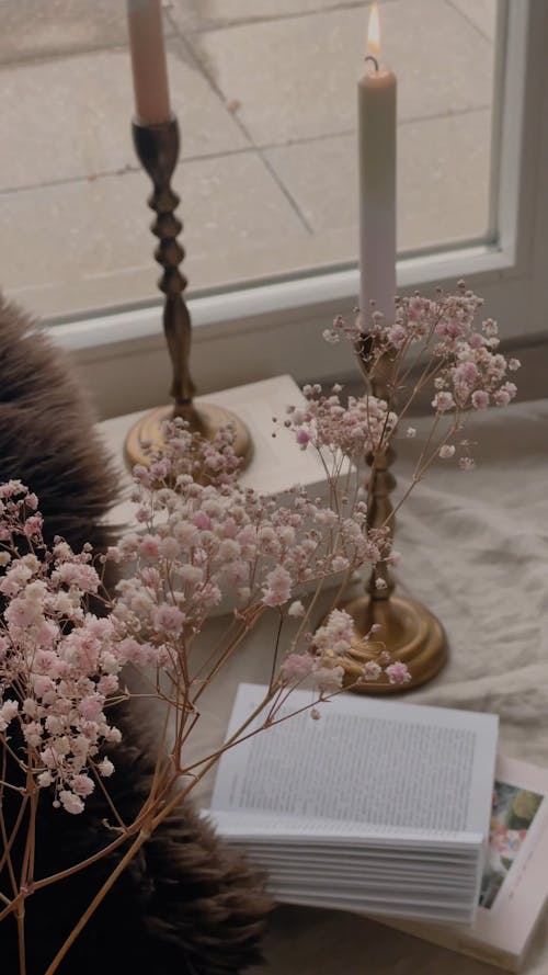 Candles and Books by a Window 