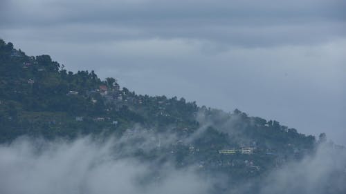 Time Lapse of Dense Clouds over a Mountain Village 