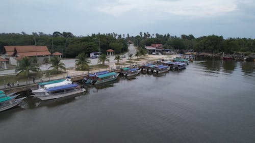 Boats on Body of Water near the Road 