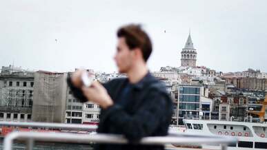 a man is looking at the city from a boat