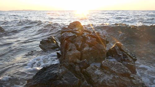 A Sea Wave Crashing against a Rock in Slow Motion