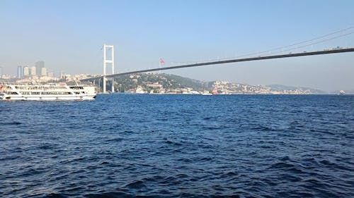 Ferry Boat Crossing under Bosphorus Bridge
