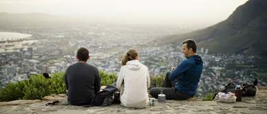 three people having a picnic at lion s head mountain south africa
