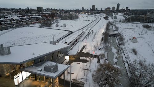 An Aerial Footage of a Moving Train on a Snow Covered Ground