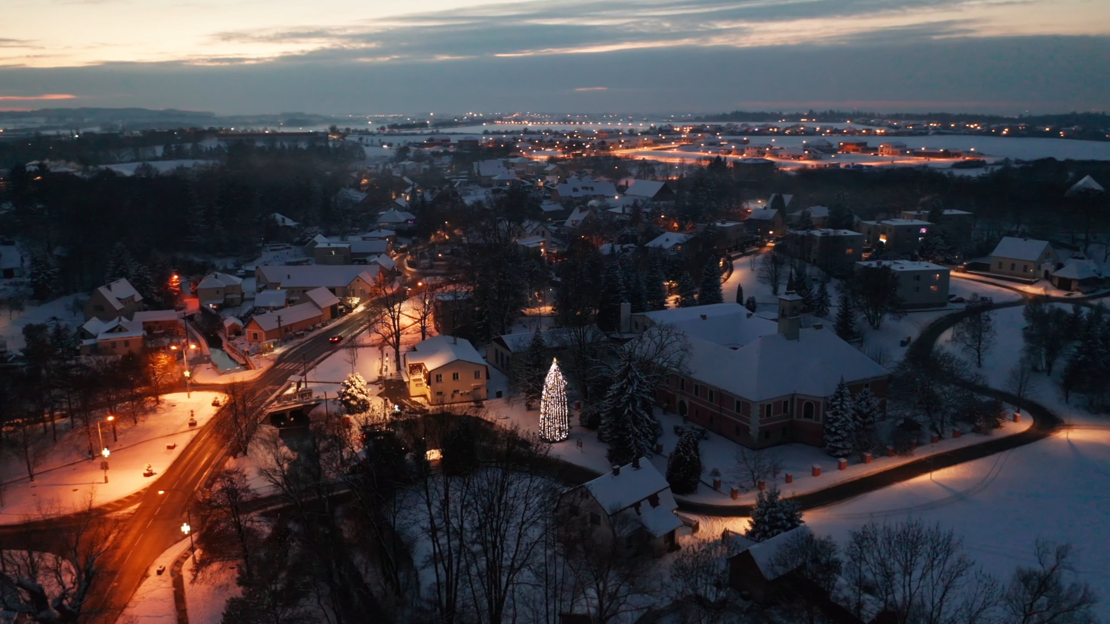 An Aerial Footage of Houses on a Snow Covered Ground with Trees at ...