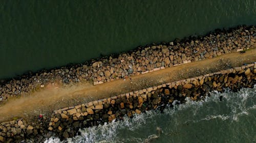 An Aerial Footage of a Concrete Dock Between Ocean