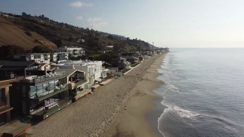 An Aerial Footage of Beautiful Houses by the Beach