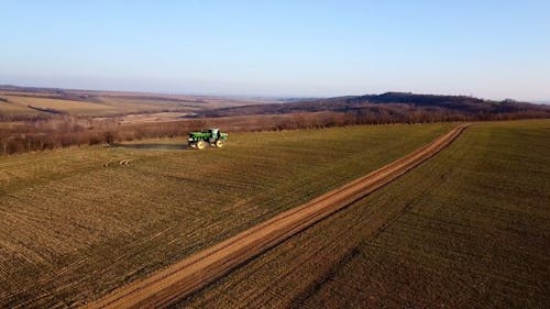 Drone Footage of a Tractor in a Field 