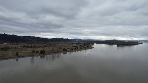 Drone Footage of a Calm River under a Cloudy Sky