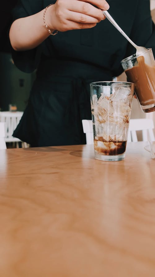 A Barista Preparing a Glass of Iced Coffee 